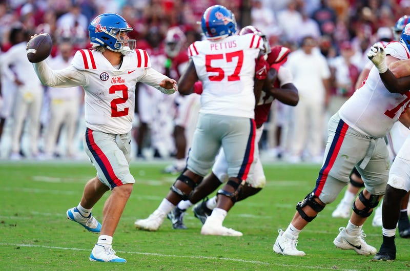 Mississippi Rebels quarterback Jaxson Dart (2) rolls out to pass against the Alabama Crimson Tide