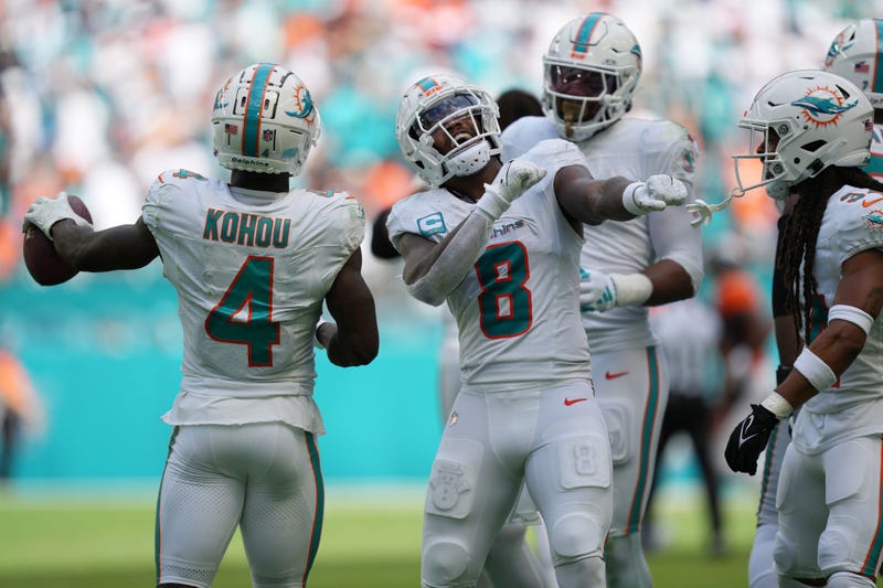 Miami Dolphins safety Jevon Holland (8) celebrates creating a turnover against the Denver Broncos that was recovered by cornerback Kader Kohou (4) during the second half of an NFL game