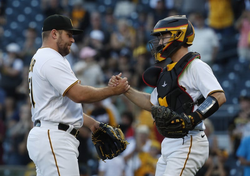 Pittsburgh Pirates relief pitcher David Bednar (51) and catcher Jason Delay (55) shake hands after defeating the Miami Marlins at PNC Park.