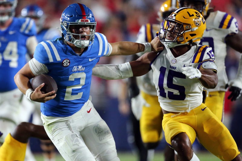 Jaxson Dart (2) runs the ball as LSU Tigers defensive back Sage Ryan (15) attempts to make the tackle