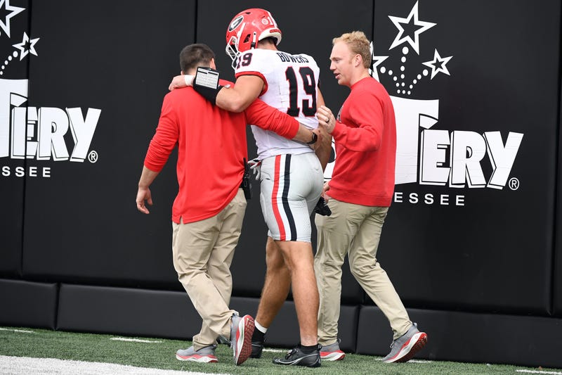 Georgia Bulldogs TE Brock Bowers walks off the field after an injury