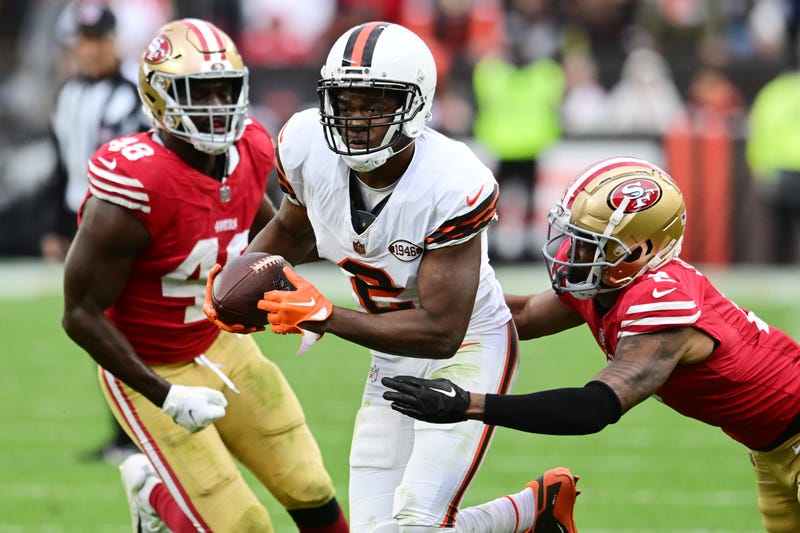 Cleveland Browns wide receiver Amari Cooper (2) runs with the ball after a catch as San Francisco 49ers cornerback Deommodore Lenoir (2) and linebacker Oren Burks (48) defend during a game at Cleveland Browns Stadium.