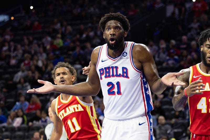 Philadelphia 76ers center Joel Embiid (21) reacts to an officials call in front of Atlanta Hawks guard Trae Young 