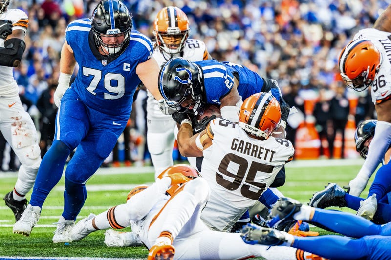 Indianapolis Colts running back Zack Moss (21) runs the ball while Cleveland Browns defensive end Myles Garrett (95) defends in the second half at Lucas Oil Stadium.