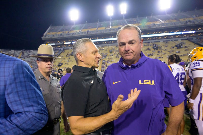 Army Black Knights head coach Jeff Monken talks with LSU Tigers assistant coach Mike Denbrock