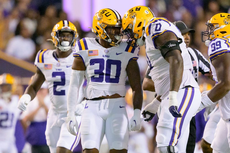 LSU Tigers linebacker Greg Penn III (30) celebrates with defensive tackle Maason Smith (0) after a sack