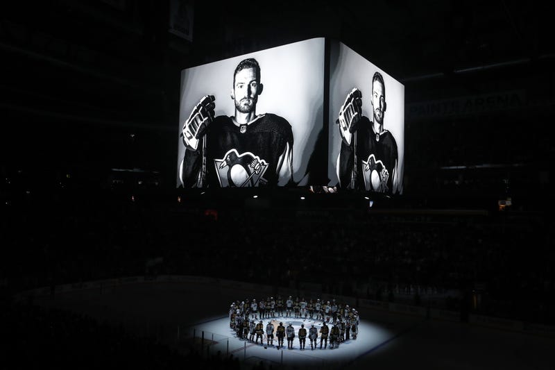  Members of the Anaheim Ducks and the Pittsburgh Penguins stand at center ice for a moment of silence at the PPG Paints Arena to honor former Penguin forward Adam Johnson (on scoreboard) who was tragically killed in a hockey related accident in Europe.