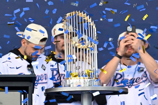 A view of the Texas Rangers team and trophy as the confetti flies during the celebration outside of the ballpark after the World Series championship parade at Globe Life Field