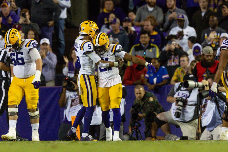 LSU Tigers running back Noah Cain (21) is congratulated by quarterback Jayden Daniels (5) after scoring a touchdown