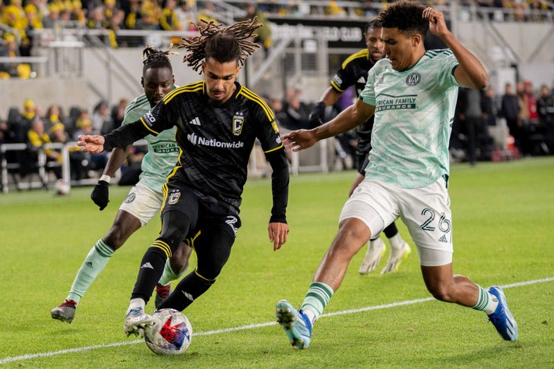 Columbus Crew defender Mohamed Farsi runs towards the goal through Atlanta United defenders