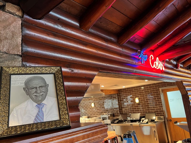 A portrait of Karl Poulos, who rescued the tavern at 6005 Gotfredson Road in Salem Township and then operated it as Karl's Cabin, sits atop a hearth at the restaurant. After a fire in February, Karl's Cabin will reopen in late November.