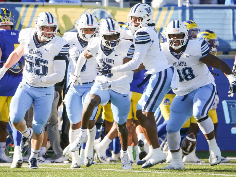 Villanova's Isas Waxter (center) celebrates his first quarter interception in the Blue Hens' 35-7 loss at Delaware Stadium, Saturday, Nov. 18, 2023.