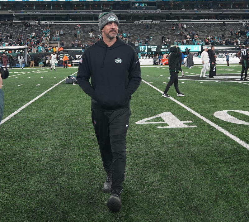 Injured Jets quarterback Aaron Rodgers walks off of the field at the end of the game as the Miami Dolphins defeated the NY Jets 34-13 at MetLife Stadium