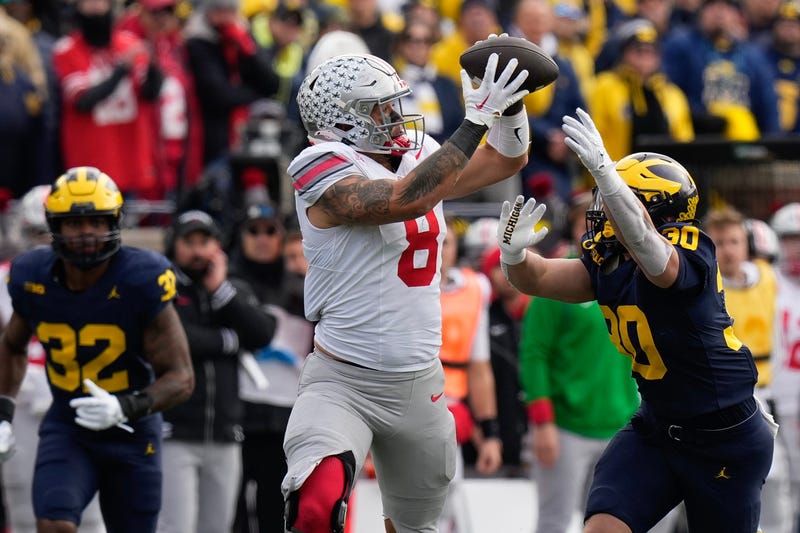 Nov 25, 2023; Ann Arbor, Michigan, USA; Ohio State Buckeyes tight end Cade Stover (8) catches a pass over Michigan Wolverines linebacker Jimmy Rolder (30) during the first half of the NCAA football game at Michigan Stadium