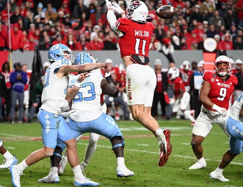 Payton Wilson impacting a pass from Drake Maye