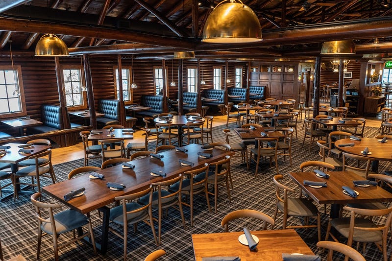 Tables sit ready for guests in the main dining room at Karl's Cabin in Salem Township on Tuesday, November 28, 2023, during a media day before the business reopens following a devastating fire earlier this year. Nine months of renovation and restoration work prepared Karl's Cabin to welcome back customers.