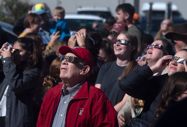 People watch the solar eclipse, Saturday, Oct. 14, 2023, at the Science Spectrum