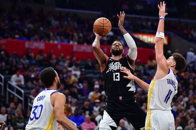Dec 2, 2023; Los Angeles, California, USA; Los Angeles Clippers forward Paul George (13) shoots against Golden State Warriors guard Stephen Curry (30) and guard Klay Thompson (11) during the second half at Crypto.com Arena.