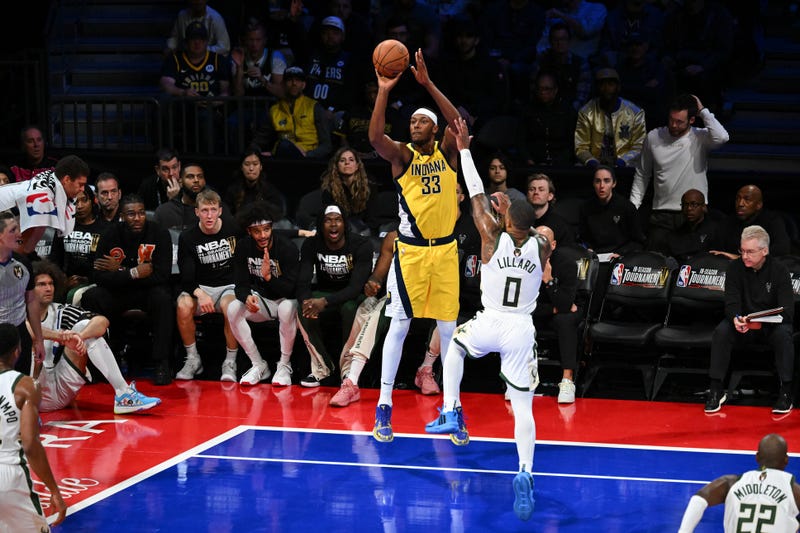 Dec 7, 2023; Las Vegas, Nevada, USA; Indiana Pacers center Myles Turner (33) shoots the basketball as Milwaukee Bucks guard Damian Lillard (0) defends during the second quarter at T-Mobile Arena. Mandatory Credit: Candice Ward-Imagn Images