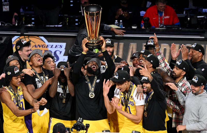 Los Angeles Lakers forward LeBron James (23) hoists the NBA Cup and celebrates with teammates after winning the NBA In-Season Tournament Championship game against the Indiana Pacers at T-Mobile Arena.