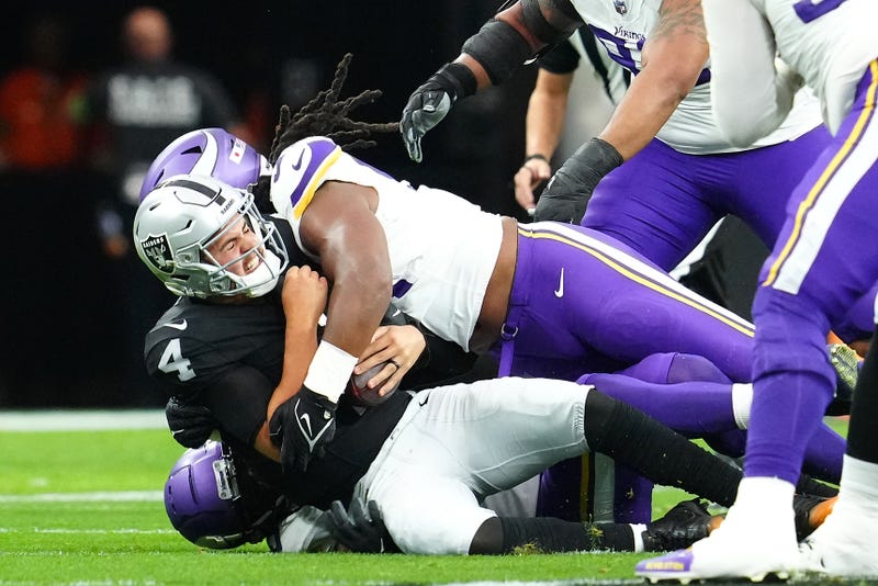 Las Vegas Raiders quarterback Aidan O'Connell is sacked by Minnesota Vikings linebacker Pat Jones II during the first quarter at Allegiant Stadium.