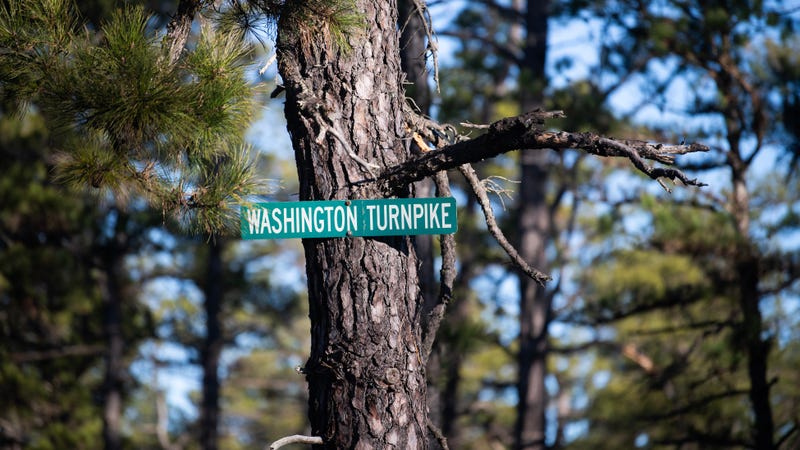 A sign is posted on Washington Turnpike in the Pine Barrens, about 7 miles away from the site where a pilot and a photog were killed when Action News' helicopter Chopper 6 crashed in a wooded area of Burlington County