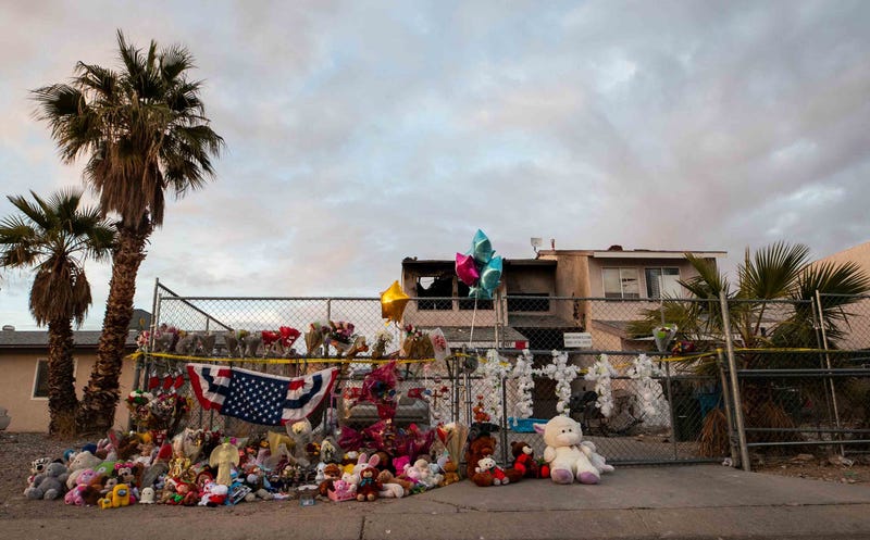 Flowers and stuffed animals adorn the outside of a Bullhead City home on Dec. 20, 2023. A Dec. 16 house fire on the property resulted in the death of five children.