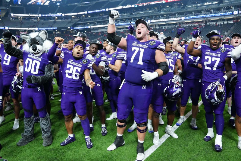 Northwestern Wildcats players sing the Wildcats fight song after defeating the Utah Utes 14-7 to win the Las Vegas Bowl at Allegiant Stadium