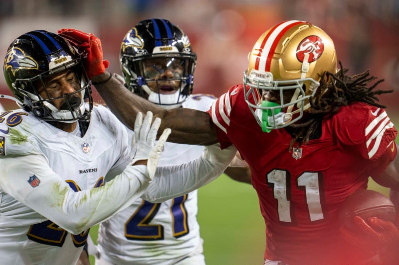 Dec 25, 2023; Santa Clara, California, USA; San Francisco 49ers wide receiver Brandon Aiyuk (11) rushes for the first down against Baltimore Ravens safety Geno Stone (26) during the fourth quarter at Levi's Stadium. 