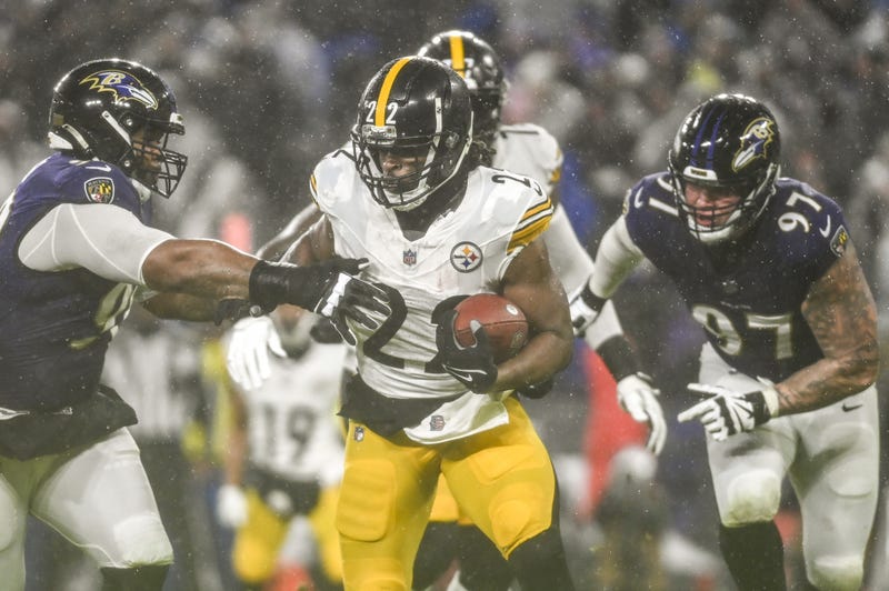 Najee Harris running through tackle