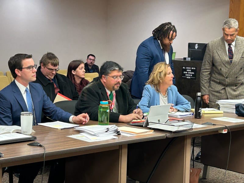 Willie Reed (blue jacket) and Shawn Wilmoth (black jacket) with attorneys