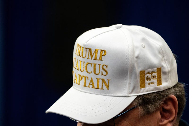 A Trump caucus captain wears a white caucus captain hat during a campaign rally at Waterloo Convention Center on Dec. 19, 2023, in Waterloo, Iowa.