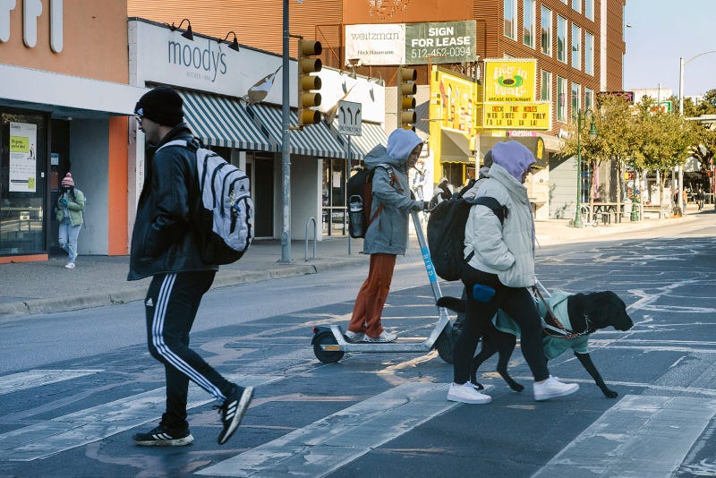 Bundled up in winter clothing, pedestrians cross Guadalupe Street near the University of Texas on Tuesday, Jan. 16, 2024.