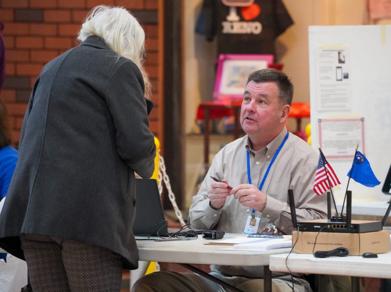 An election worker checks in a voter at a voting site in south Reno, Nevada, during the Feb. 6, 2024 presidential preference primary.
