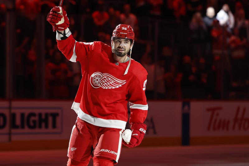 Feb 10, 2024; Detroit, Michigan, USA; Detroit Red Wings defenseman Jake Walman (96) is named one of the three stars of the game against Vancouver Canucks goaltender Casey DeSmith (29) in overtime at Little Caesars Arena
