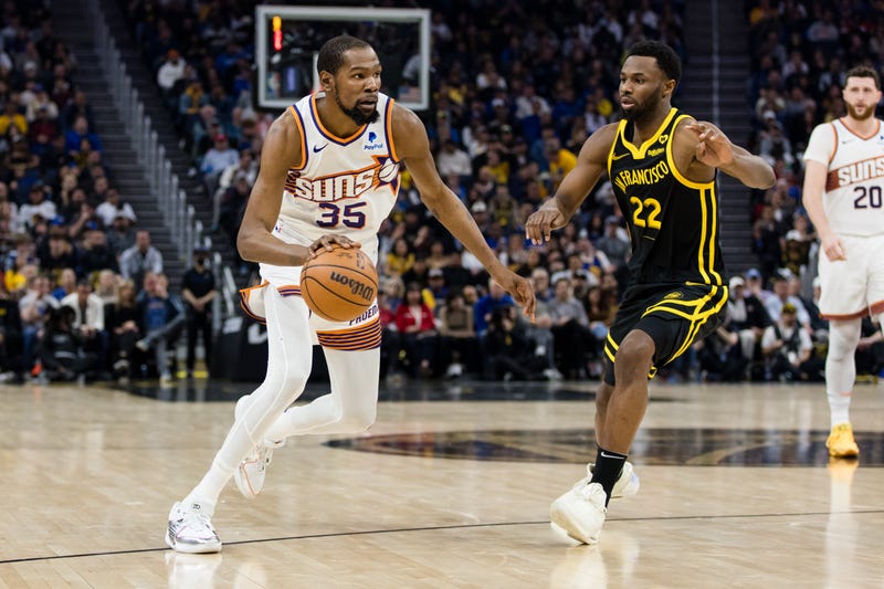 Feb 10, 2024; San Francisco, California, USA; Phoenix Suns forward Kevin Durant (35) drives past Golden State Warriors forward Andrew Wiggins (22) during the first half at Chase Center.