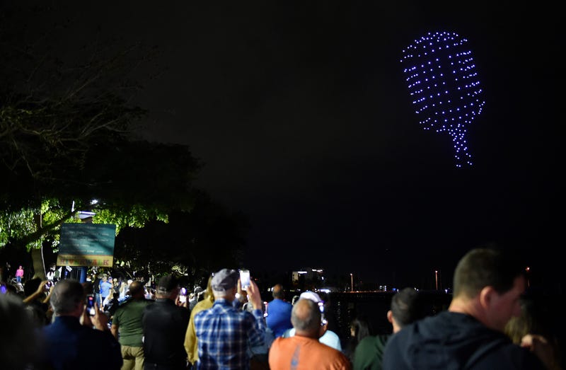 Spectators watch a drone show over the Manatee River in Florida on Feb. 16, 2024