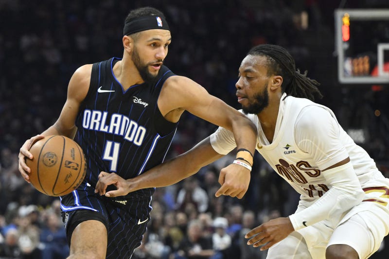 Feb 22, 2024; Cleveland, Ohio, USA; Orlando Magic guard Jalen Suggs (4) dribbles beside Cleveland Cavaliers guard Darius Garland (10) in the second quarter at Rocket Mortgage FieldHouse.