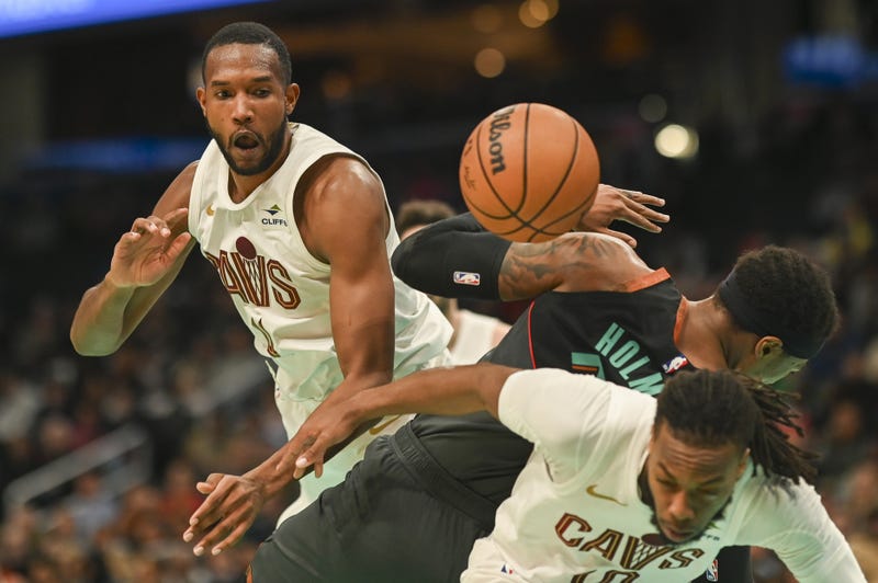 Feb 25, 2024; Washington, District of Columbia, USA; Cleveland Cavaliers forward Evan Mobley (4) blocks Washington Wizards forward Richaun Holmes (22) shot as he falls on guard Darius Garland (10) during the second half at Capital One Arena.