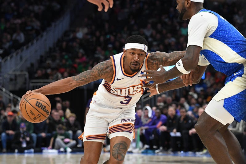 Mar 17, 2024; Milwaukee, Wisconsin, USA; Phoenix Suns guard Bradley Beal (3) drives to the basket against Milwaukee Bucks forward Bobby Portis (9) in the second half at Fiserv Forum. Mandatory Credit: Michael McLoone-Imagn Images