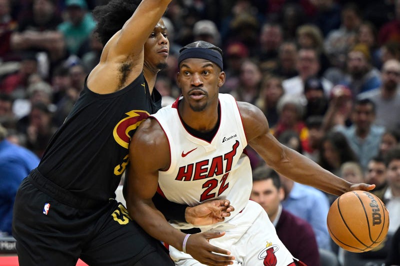 Mar 20, 2024; Cleveland, Ohio, USA; Miami Heat forward Jimmy Butler (22) drives against Cleveland Cavaliers forward Isaac Okoro (35) in the second quarter at Rocket Mortgage FieldHouse. 