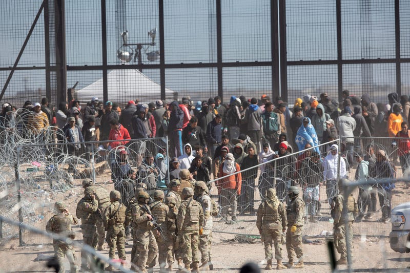 Migrants who breached the barriers set up on the Rio Grande in El Paso, Texas by Texas National Guard on March 21, 2024