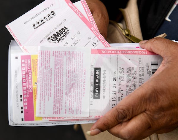 Woman holding an assortment of lottery tickets