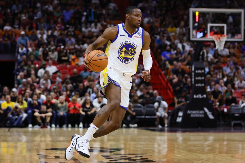 Mar 26, 2024; Miami, Florida, USA; Golden State Warriors forward Jonathan Kuminga (00) dribbles the basketball against the Miami Heat during the first quarter at Kaseya Center.