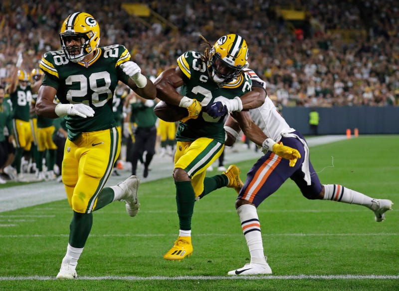 Sep 18, 2022; Green Bay, Wisconsin, USA; Green Bay Packers running back AJ Dillon (28) blocks for running back Aaron Jones (33) as he scores a touchdown against Chicago Bears safety Jaquan Brisker (9) in the second quarter during their football game at Lambeau Field. Mandatory Credit: Dan Powers/USA TODAY NETWORK-Wisconsin