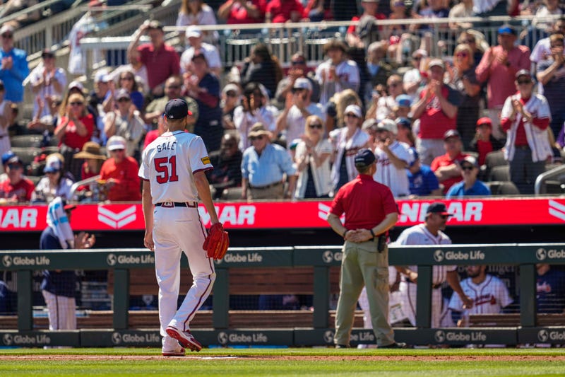 Atlanta Braves starting pitcher Chris Sale leaves the field to applause