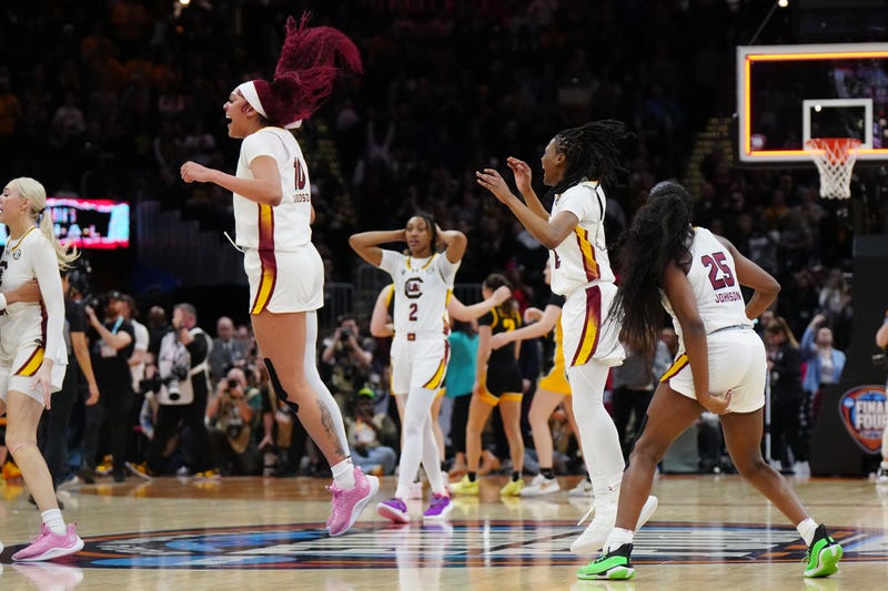 South Carolina Gamecocks center Kamilla Cardoso (10) and South Carolina Gamecocks guard MiLaysia Fulwiley (12) and guard Raven Johnson (25) celebrate after defeating the Iowa Hawkeyes in the finals of the Final Four of the womens 2024 NCAA Tournament at Rocket Mortgage FieldHouse.