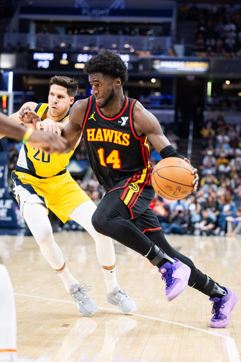 Apr 14, 2024; Indianapolis, Indiana, USA; Atlanta Hawks forward AJ Griffin (14) dribbles the ball while Indiana Pacers forward Doug McDermott (20) defends in the second half at Gainbridge Fieldhouse. Mandatory Credit: Trevor Ruszkowski-USA TODAY Sports