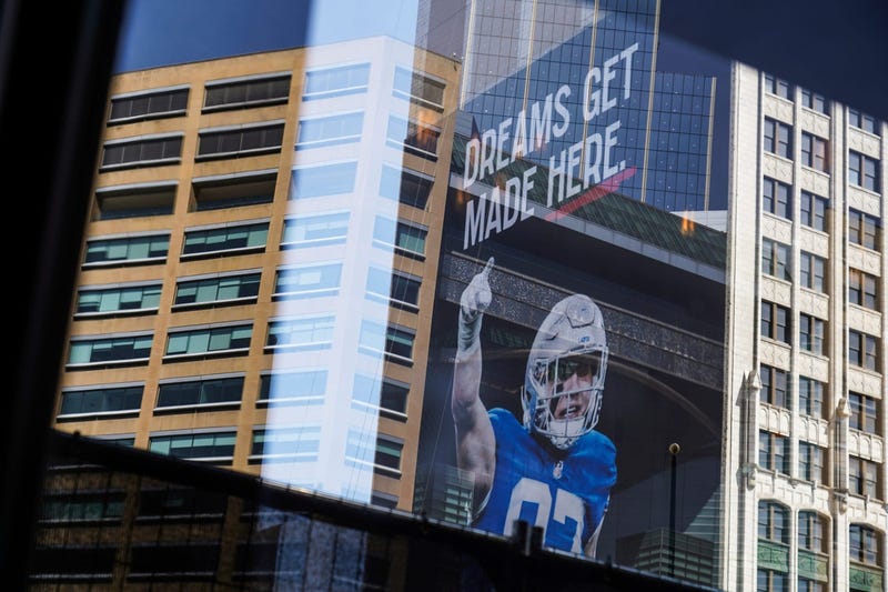 A sign posted on the side of a building hangs as work continues on the setup for the upcoming NFL Draft