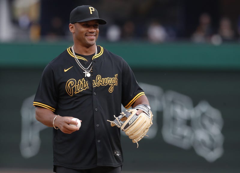 Russell Wilson in Pirates jersey with ball and glove
